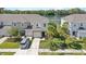 Attractive townhouse with lush landscaping, palm trees, and a serene lake view at 7916 Evergreen Creek Ct, Riverview, FL 33578