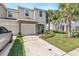Charming townhome with a well-maintained lawn, inviting walkway, and attached garage at 7916 Evergreen Creek Ct, Riverview, FL 33578