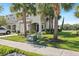 A townhouse featuring a well maintained front yard, green grass, and palm trees at 7916 Evergreen Creek Ct, Riverview, FL 33578