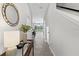 Bright hallway leading to a kitchen with a breakfast bar and a view of the backyard at 7916 Evergreen Creek Ct, Riverview, FL 33578