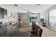 Modern kitchen with stainless steel appliances, dark cabinets, granite countertops, and open to living area at 7916 Evergreen Creek Ct, Riverview, FL 33578