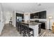 Modern kitchen features a large island, granite countertops, and stainless steel appliances at 7916 Evergreen Creek Ct, Riverview, FL 33578