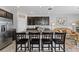 Modern kitchen features stainless steel appliances, dark cabinets, and granite countertops with island at 7916 Evergreen Creek Ct, Riverview, FL 33578
