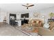 Open-concept living area with a ceiling fan flowing into the kitchen with a breakfast bar at 7916 Evergreen Creek Ct, Riverview, FL 33578