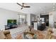 Comfortable living room featuring tile floors, a ceiling fan, leather couches, and an open floorplan at 7916 Evergreen Creek Ct, Riverview, FL 33578