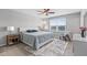 Well-lit primary bedroom features a ceiling fan and a large window overlooking a serene view at 7916 Evergreen Creek Ct, Riverview, FL 33578