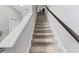 Carpeted stairway with white and wood railings leading to the upper level of the home at 7916 Evergreen Creek Ct, Riverview, FL 33578