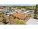 Aerial view of a single-Gathering home with a lush lawn and landscaping, complemented by a chain-link fence at 828 Fox Hills Dr, Sun City Center, FL 33573