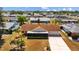 Aerial view of single-story home featuring a brown roof, a long driveway, and a small, screened-in front porch at 828 Fox Hills Dr, Sun City Center, FL 33573