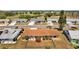 Overhead view of a single-Gathering home with a well-kept lawn, lush landscaping and proximity to a golf course at 828 Fox Hills Dr, Sun City Center, FL 33573