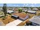 Aerial view showcasing a single-Gathering home with a well-kept lawn, long driveway, and a two-car garage at 828 Fox Hills Dr, Sun City Center, FL 33573