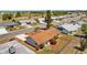Aerial view of a single-Gathering home with a well-kept lawn and proximity to a golf course and lush landscaping at 828 Fox Hills Dr, Sun City Center, FL 33573