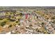An aerial view of a neighborhood featuring numerous single-story homes on a sunny day at 828 Fox Hills Dr, Sun City Center, FL 33573
