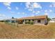 The backyard features green chain link fencing, manicured lawn, and a flower bed next to the house at 828 Fox Hills Dr, Sun City Center, FL 33573