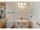 Stylish bathroom featuring a vanity with sink, decorative lighting, and a shower behind a glass wall at 828 Fox Hills Dr, Sun City Center, FL 33573