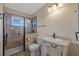 Elegant bathroom showcases a glass-enclosed shower, vanity with sink, and decorative lighting fixtures at 828 Fox Hills Dr, Sun City Center, FL 33573