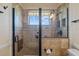 Modern bathroom with a glass-enclosed shower featuring neutral tiling and fixtures at 828 Fox Hills Dr, Sun City Center, FL 33573