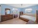 Bedroom with wood furniture, wood flooring and an abundance of light from two windows at 828 Fox Hills Dr, Sun City Center, FL 33573