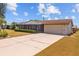 Charming single-story home with an attached garage and a long private driveway at 828 Fox Hills Dr, Sun City Center, FL 33573