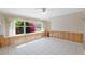 Florida room with tile flooring, wood-paneled walls, and an abundance of natural light through a large window at 828 Fox Hills Dr, Sun City Center, FL 33573