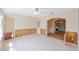 Bright Florida room with tile flooring, wood-paneled walls, and an entrance leading to dining room at 828 Fox Hills Dr, Sun City Center, FL 33573