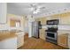 Kitchen with stainless steel appliances, light countertops, and wood flooring at 828 Fox Hills Dr, Sun City Center, FL 33573