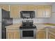 Kitchen featuring stainless steel stove and microwave with wood cabinets at 828 Fox Hills Dr, Sun City Center, FL 33573