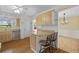 Kitchen area with stainless steel dishwasher and an eating bar with two bar stools at 828 Fox Hills Dr, Sun City Center, FL 33573