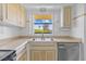 Kitchen with stainless steel sink, cabinets and dishwasher at 828 Fox Hills Dr, Sun City Center, FL 33573