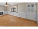 Bright living room features hardwood floors, wainscotting, and a charming fireplace at 828 Fox Hills Dr, Sun City Center, FL 33573