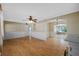 Open-concept living room with hardwood floors, wainscotting, and seamless transitions to other living areas at 828 Fox Hills Dr, Sun City Center, FL 33573