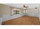 Bright living room featuring hardwood floors, paneled walls, ceiling fan, and natural light from a window at 828 Fox Hills Dr, Sun City Center, FL 33573