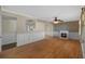 Spacious living room with hardwood floors, wainscotting, and a cozy fireplace at 828 Fox Hills Dr, Sun City Center, FL 33573