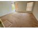Empty bedroom featuring three windows with blinds and an empty light pink carpet at 8635 Braxton Dr, Hudson, FL 34667