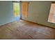 Vacant bedroom with three windows with blinds, neutral walls, and carpeted floors needing updates at 8635 Braxton Dr, Hudson, FL 34667