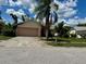 Modest single Gathering home showing a yard and driveway needing maintenance on a sunny day at 8635 Braxton Dr, Hudson, FL 34667