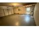 A well-lit garage featuring an automatic door, a side entrance, and plenty of open space at 8635 Braxton Dr, Hudson, FL 34667