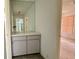 Hallway featuring a built-in vanity with a mirror and access to the bathroom and bedroom at 8635 Braxton Dr, Hudson, FL 34667