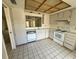 Bright kitchen with white cabinets, appliances, and tiled floor at 8635 Braxton Dr, Hudson, FL 34667