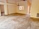 Bright living room featuring a chandelier and a view into the kitchen at 8635 Braxton Dr, Hudson, FL 34667