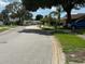 Neighborhood street with well-maintained lawns and mature trees; blue truck on the right at 8635 Braxton Dr, Hudson, FL 34667