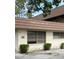 The building displays prominent numbering and multiple windows, framed by lush bushes at 8850 Dr Martin Luther King Jr N St # 8850, St Petersburg, FL 33702