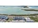 Beautiful aerial view of waterfront condos surrounded by lush tropical foliage and road at 9 Forbes Pl # 310, Dunedin, FL 34698