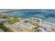 Aerial view of the complex with multiple buildings, parking, pool, beach, and intercoastal water views at 9 Forbes Pl # 310, Dunedin, FL 34698