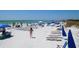 Beautiful beach scene with chairs, umbrellas, and people enjoying a day in the sun at 9 Forbes Pl # 310, Dunedin, FL 34698