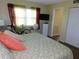 Bedroom with a bed, window with sheer curtains, and a doorway to another room at 9 Forbes Pl # 310, Dunedin, FL 34698