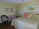 Bright bedroom with a comfortable bed, fishing poles, and tropical-themed decor at 9 Forbes Pl # 310, Dunedin, FL 34698
