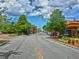 Scenic street view featuring colorful downtown buildings, parked cars, and vibrant landscaping at 9 Forbes Pl # 310, Dunedin, FL 34698