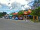 Vibrant downtown street features colorful buildings and ample parking for shops at 9 Forbes Pl # 310, Dunedin, FL 34698