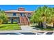 Charming raised beach house with access ramp nestled near the shore and palm trees at 9 Forbes Pl # 310, Dunedin, FL 34698